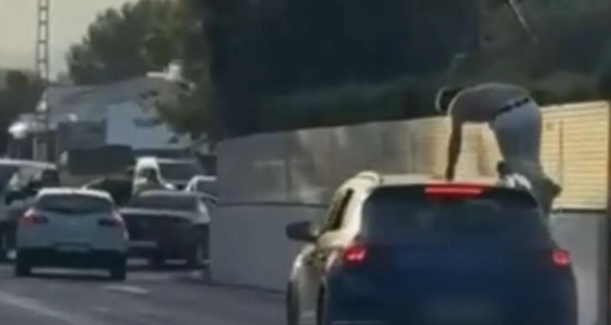Il monte sur le toit d'une voiture en marche et se fait arrêter par la police